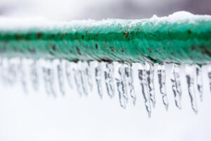 Icicles on a green pipe