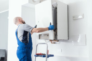 Technician installing a residential boiler