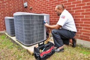 HVAC technician maintaining an air conditioner