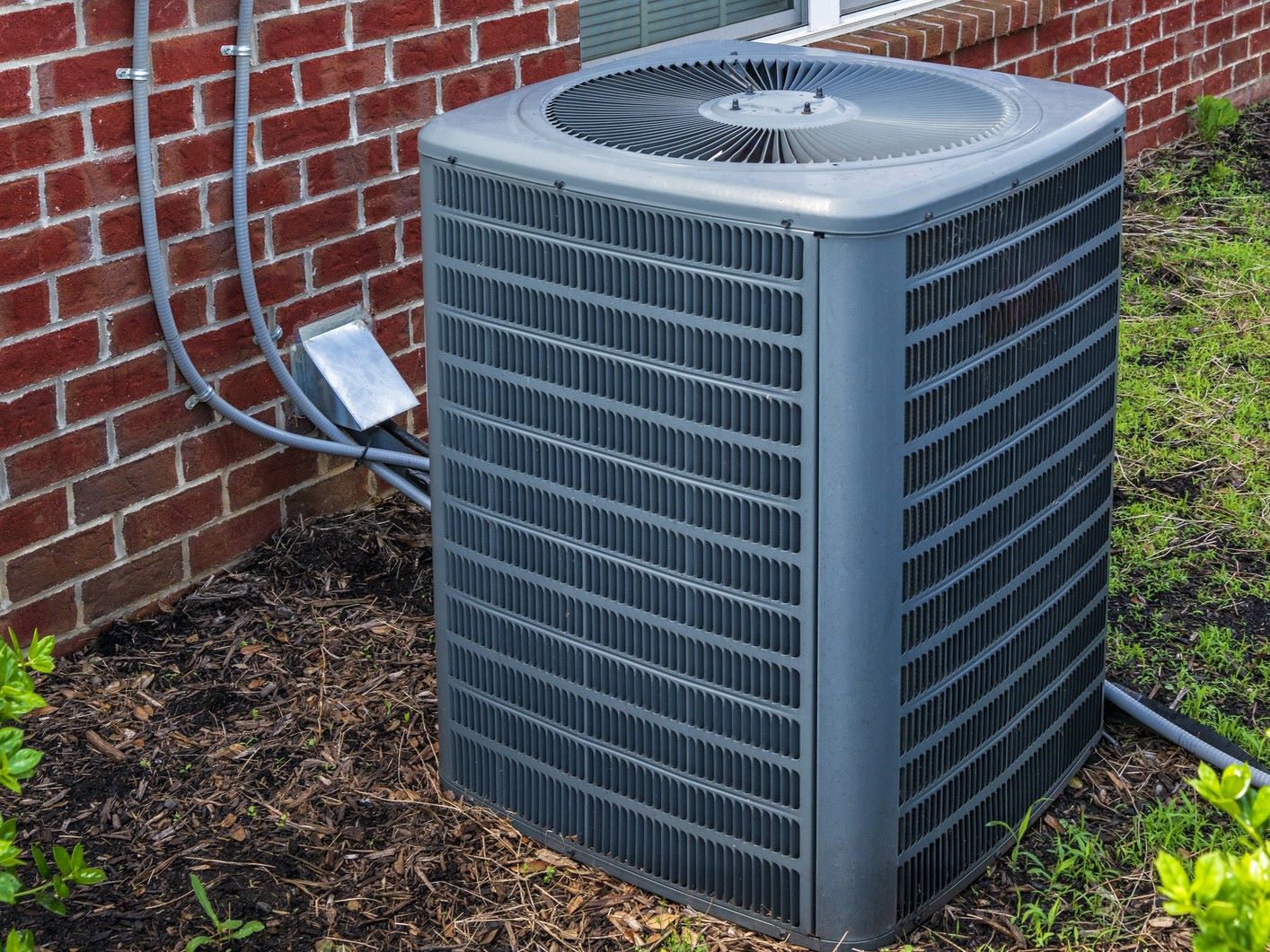 Air conditioner outside of a brick home