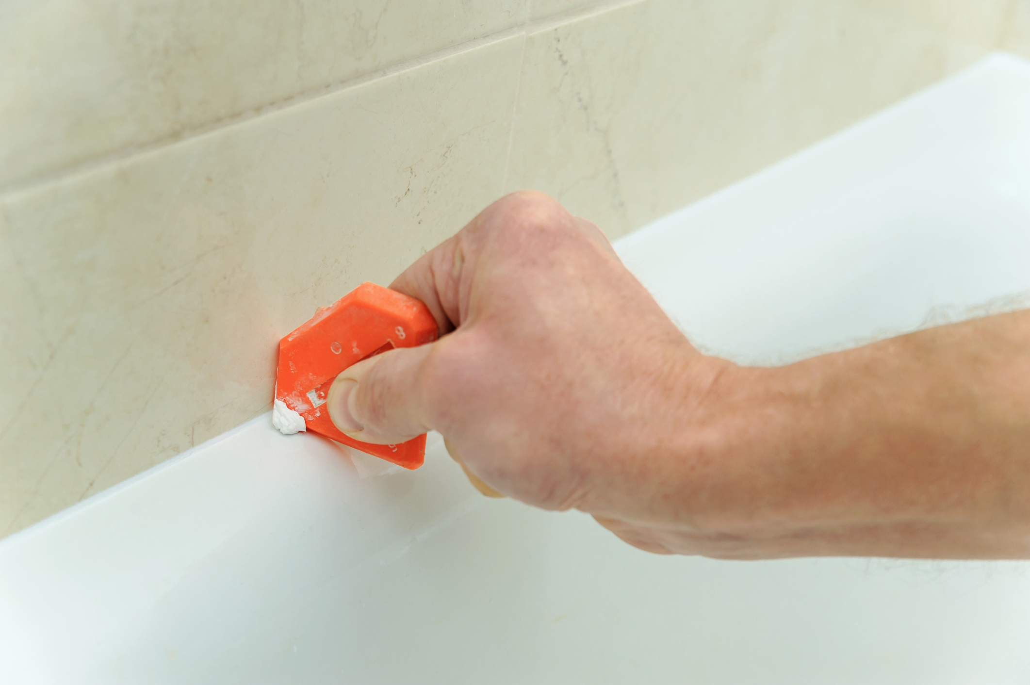 remove caulking bathroom sink