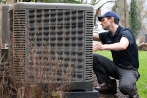 HVAC technician inspecting an air conditioner